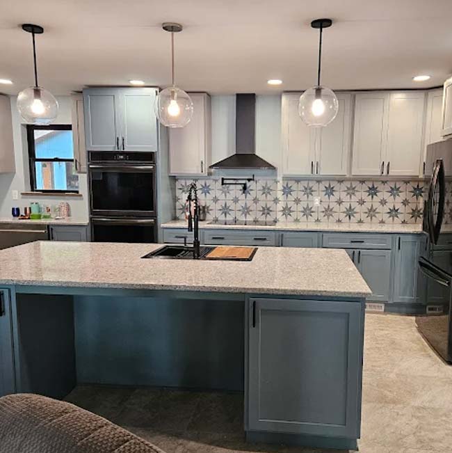 Modern kitchen with blue cabinets and licensed & insured electrical work in Wisconsin Rapids.