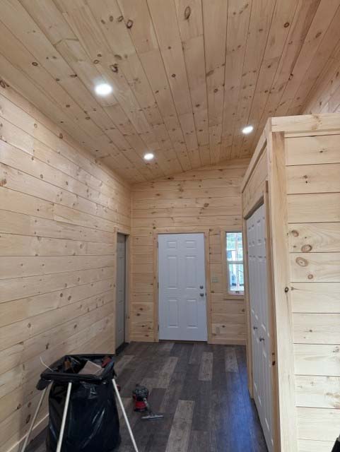 Interior of a wooden cabin in Wisconsin Rapids with a white door, closet, and electrician's tools.