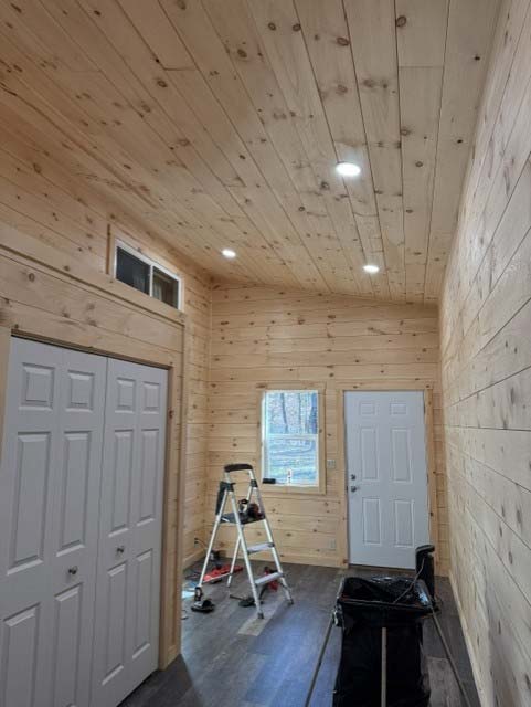 A small wooden room in Wisconsin Rapids with a white door, window, and electrician’s tools on the floor.