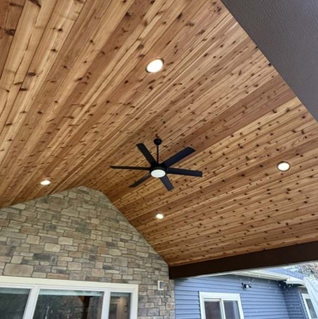 Wood-paneled ceiling with black fan, recessed lights, and Electrical work in Wisconsin Rapids.